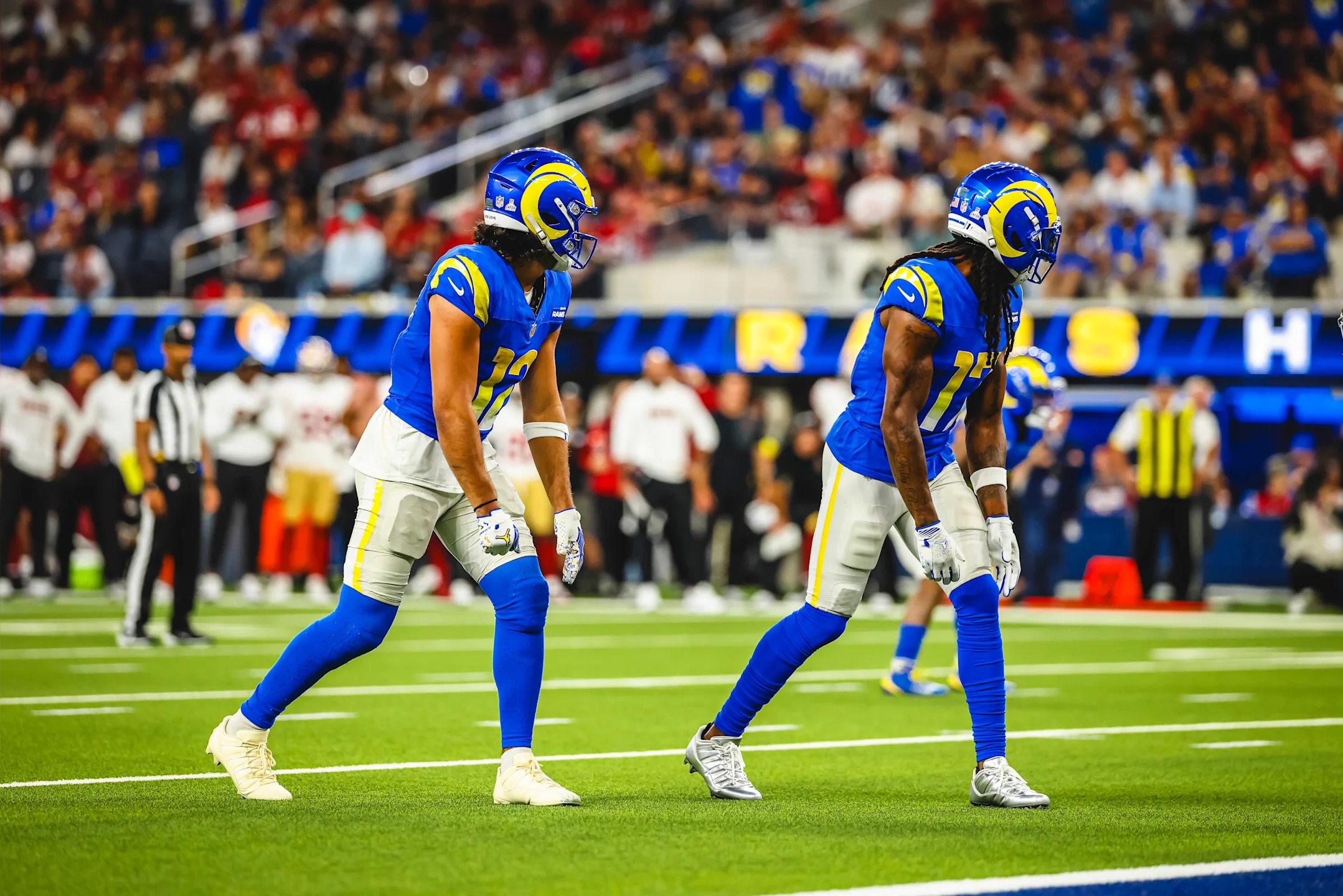Los Angeles Rams wide receivers Davante Adams and Puka Nacua stand ready before a play during an October 2025 NFL game.