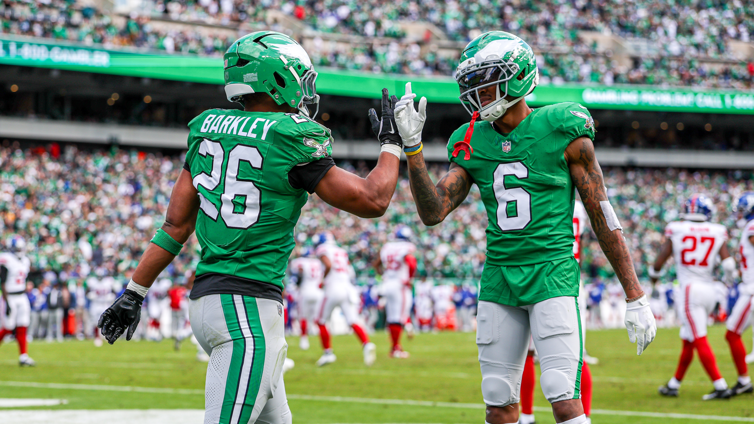 Eagles stars Saquon Barkley and DeVonta Smith celebrate in a 38-20 win over the Giants in Week 8 of the 2025 NFL season.