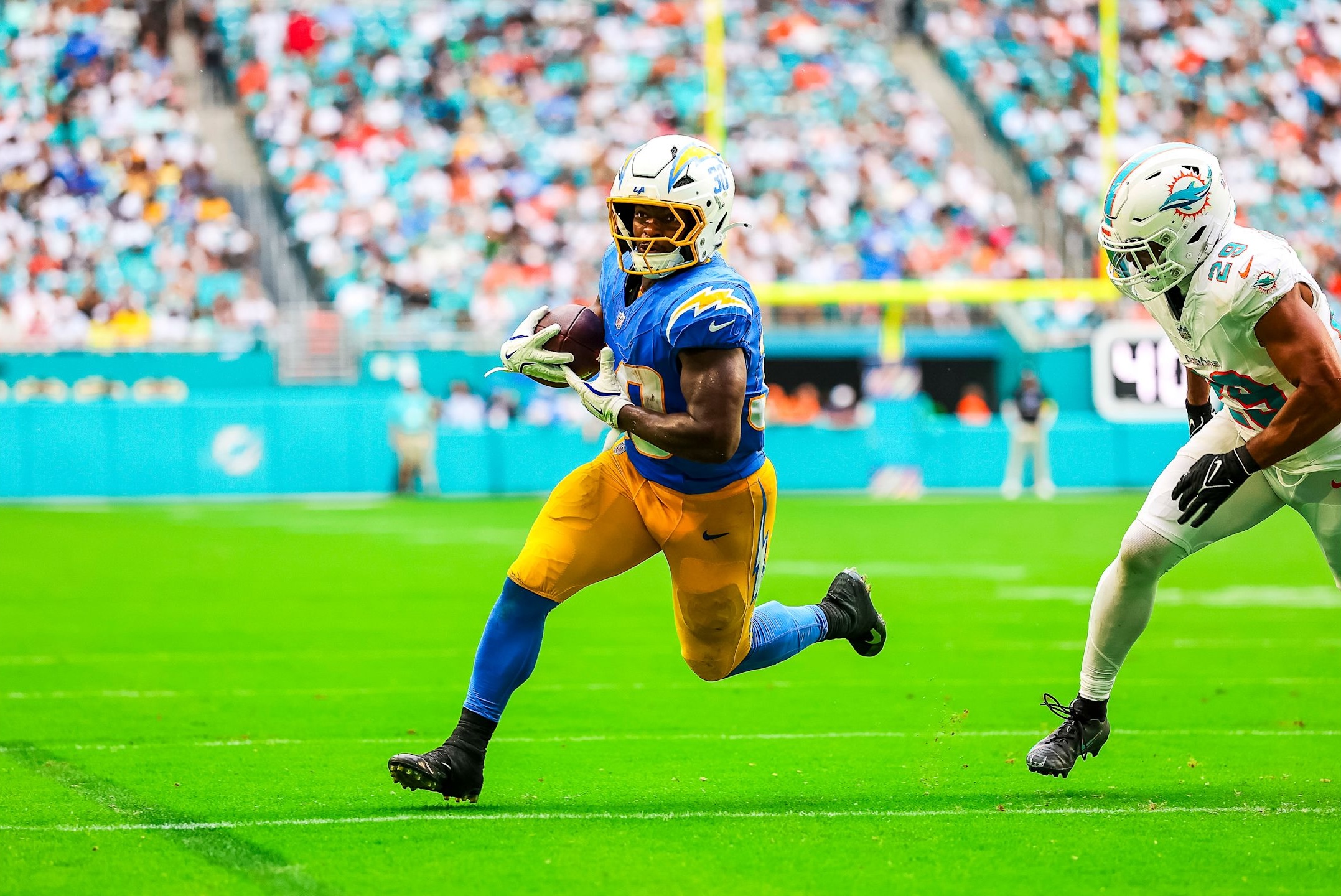Chargers running back Kimani Vidal runs into the end zone for a touchdown catch in a 29-27 win over the Dolphins in Week 6 of the 2025 NFL season.