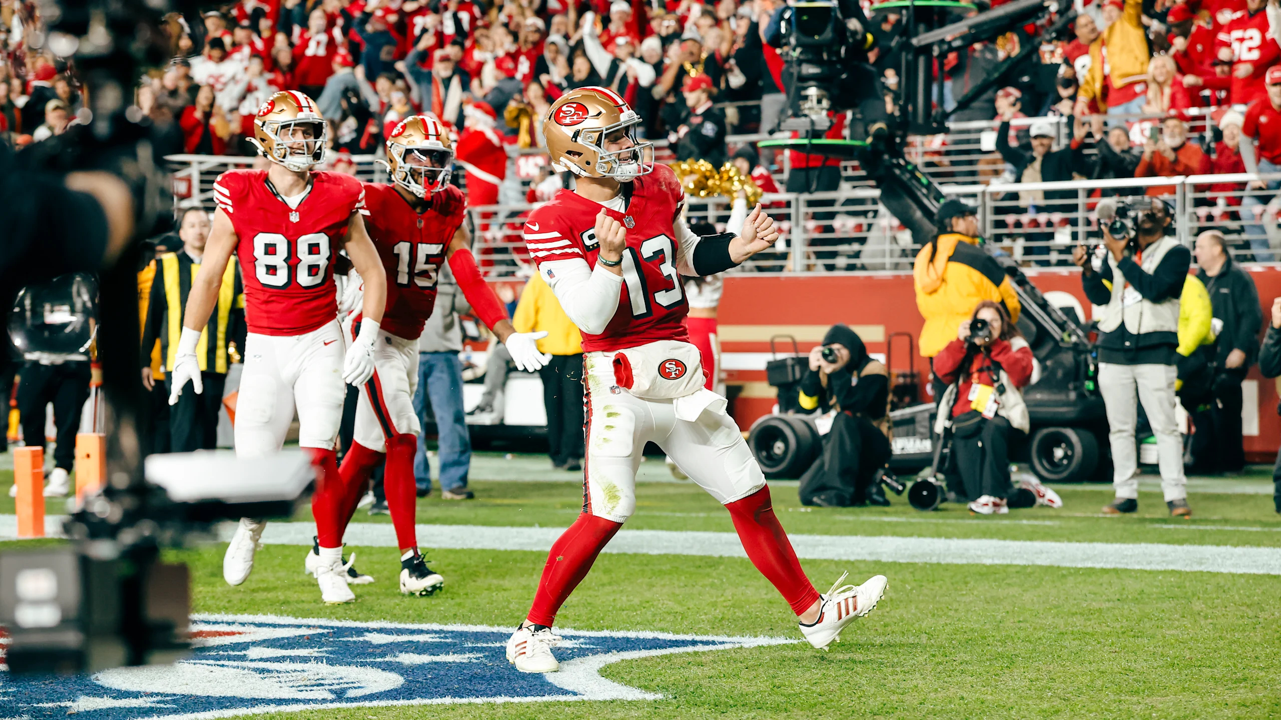 San Francisco 49ers quarterback Brock Purdy celebrates a touchdown run against the Chicago Bears on Sunday Night Football in December 2025.