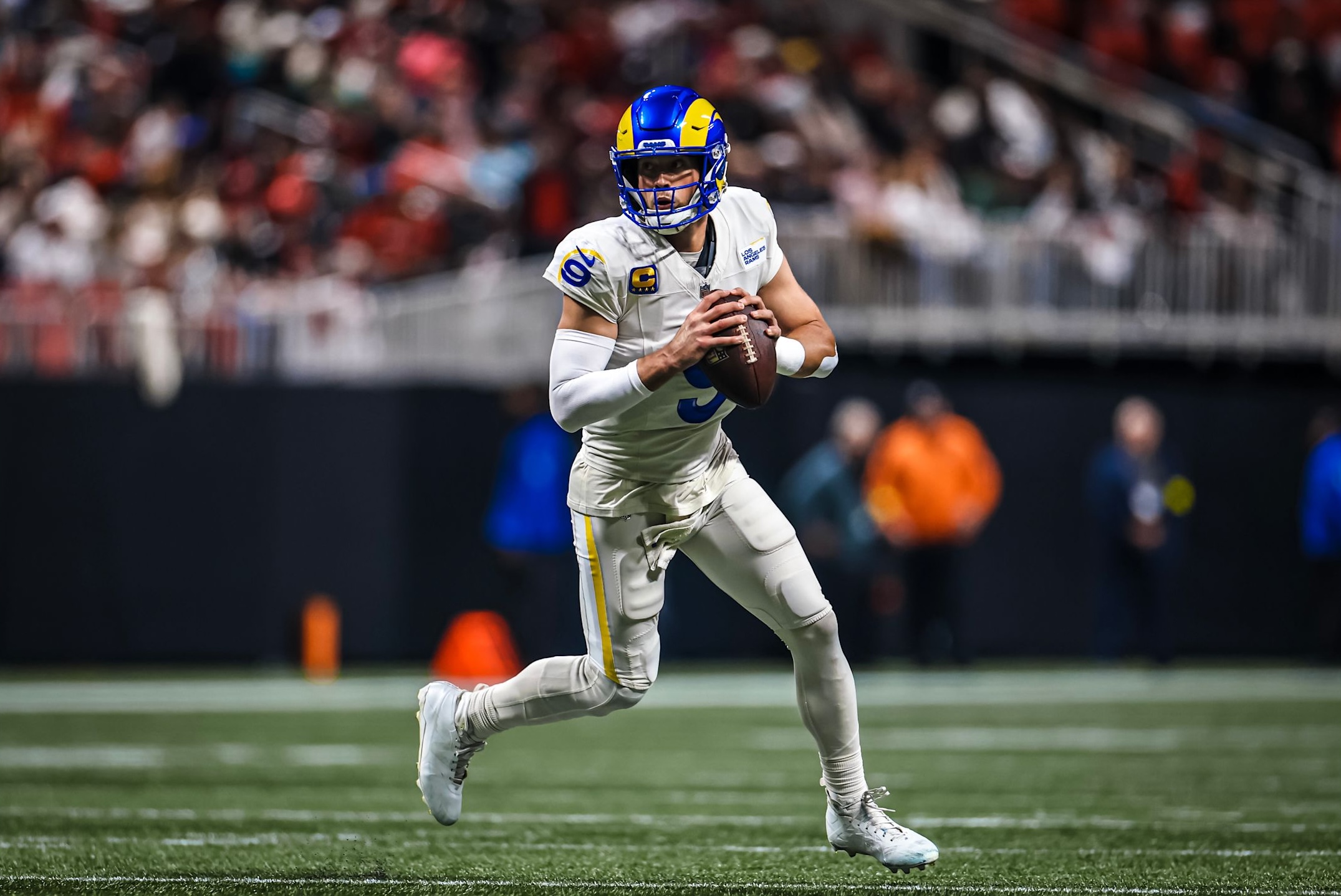 Rams quarterback Matthew Stafford rolls out in a 27-24 loss to the Falcons in Week 17 of the 2025 NFL season.