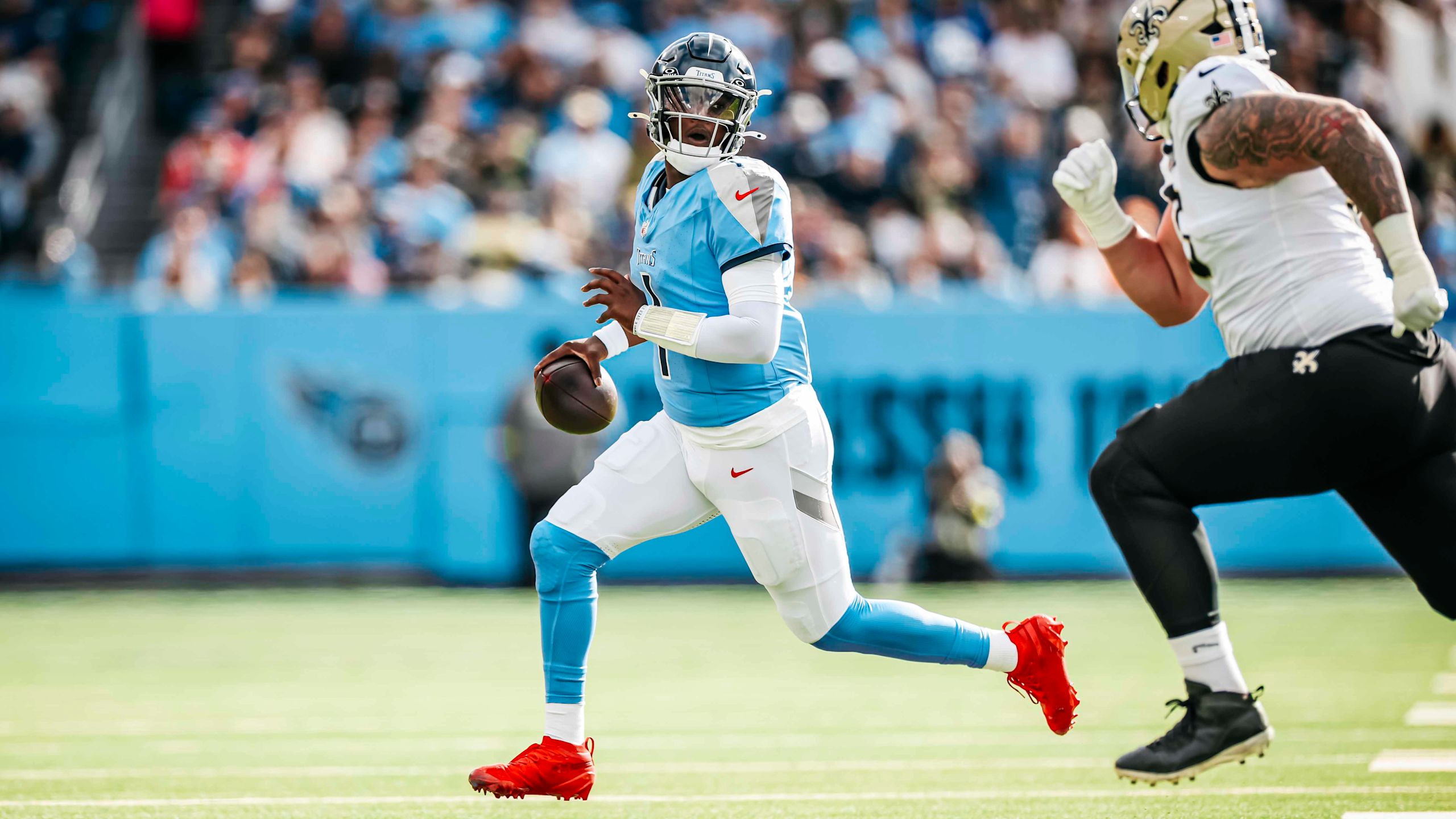 Titans quarterback Cameron Ward scrambles and looks down the field in a 34-26 loss to the Saints in Week 17 of the 2025 NFL season.