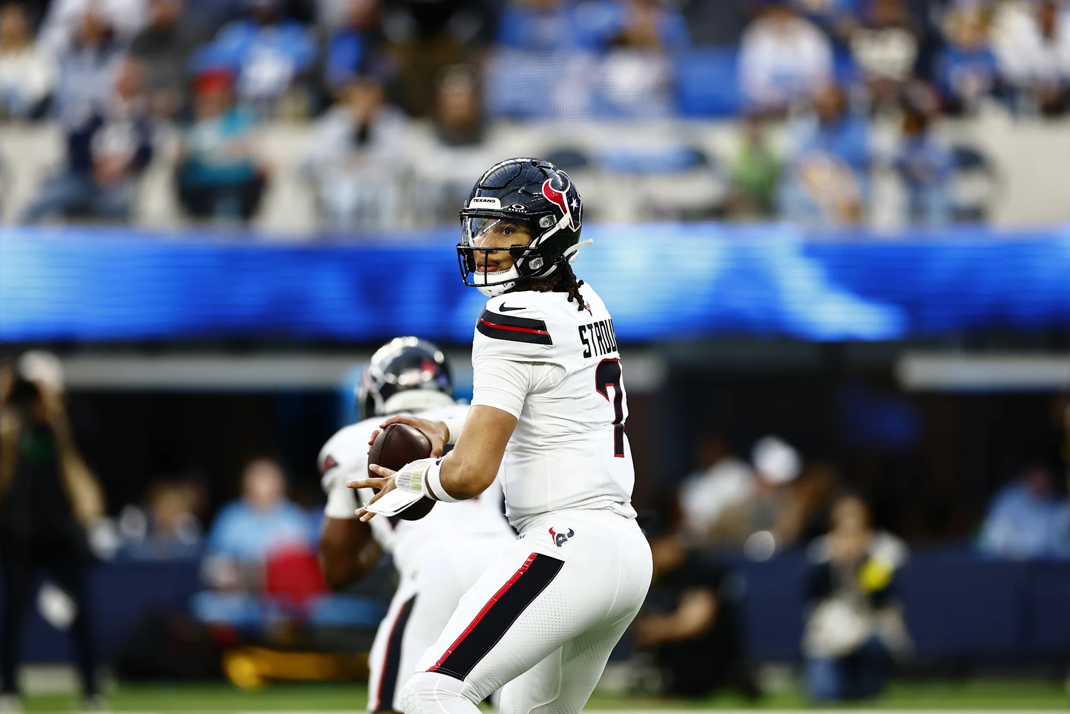 Houston Texans quarterback drops back to pass in a 2025 NFL game against the Los Angeles Chargers.
