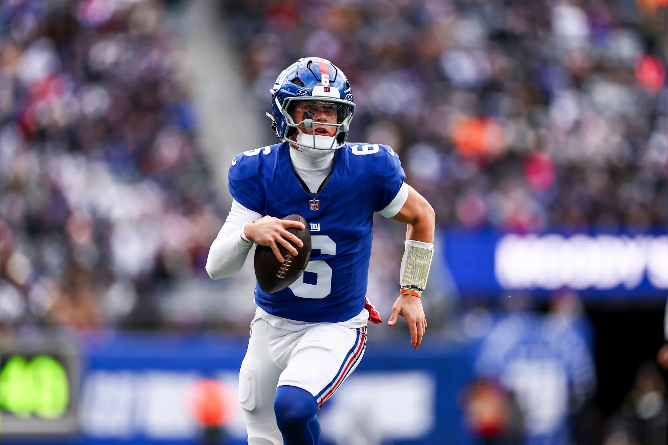 New York Giants quarterback Jaxson Dart runs with the football during a 2025 NFL Week 18 game against the Dallas Cowboys.